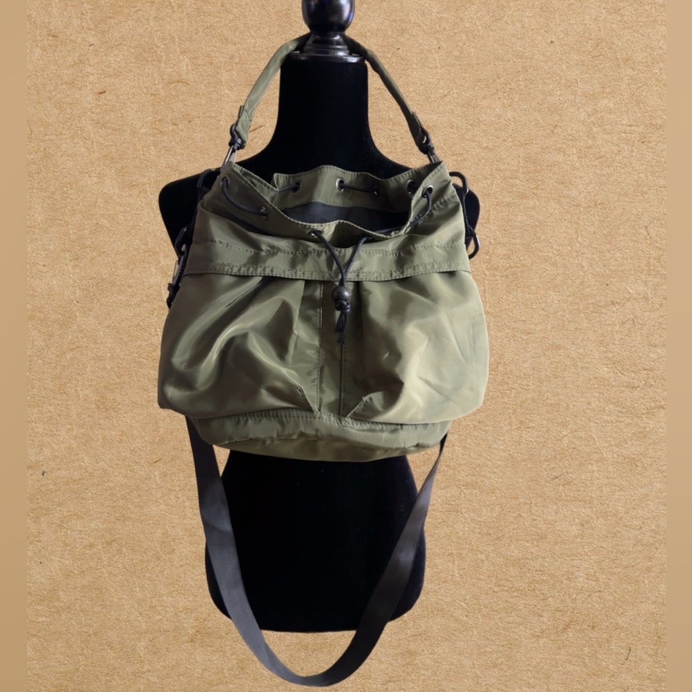 Women's crossbody bucket bag, nylon material, drawstring closure.